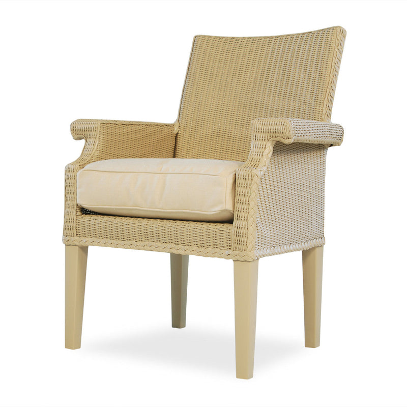 Beige wicker armchair with a cushion on a white background