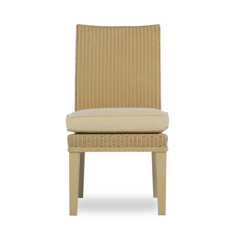 An armless wicker dining chair with a beige cushion, part of the Lloyd Flanders Hamptons collection.