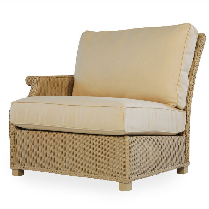 Beige wicker chair with cushions on a white background