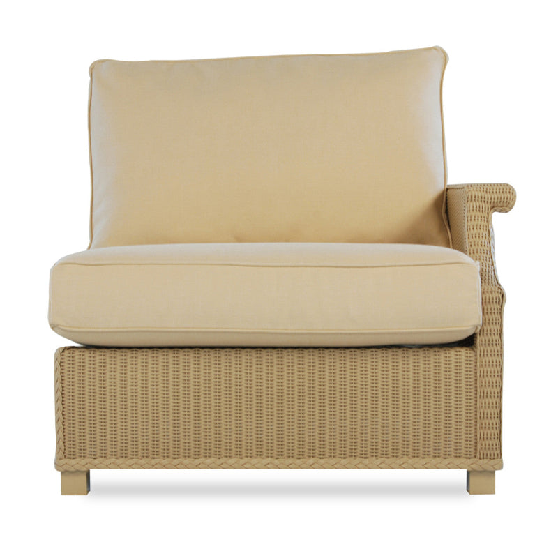A beige wicker left arm sectional chair with a cushioned seat and backrest, designed for outdoor patio seating.