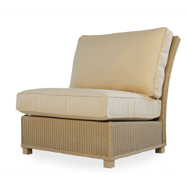 Beige wicker chair with cream cushions on a white background