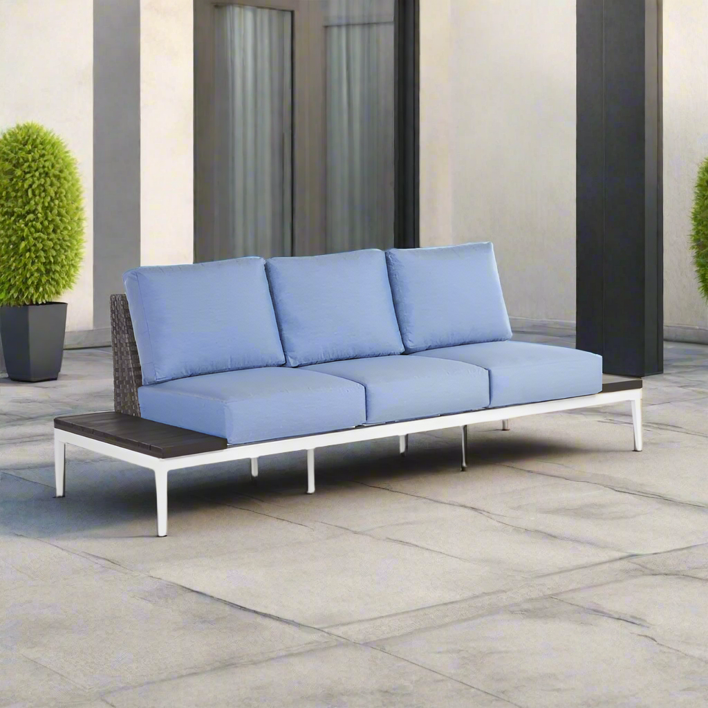 Blue outdoor sofa with wooden armrests on a patio