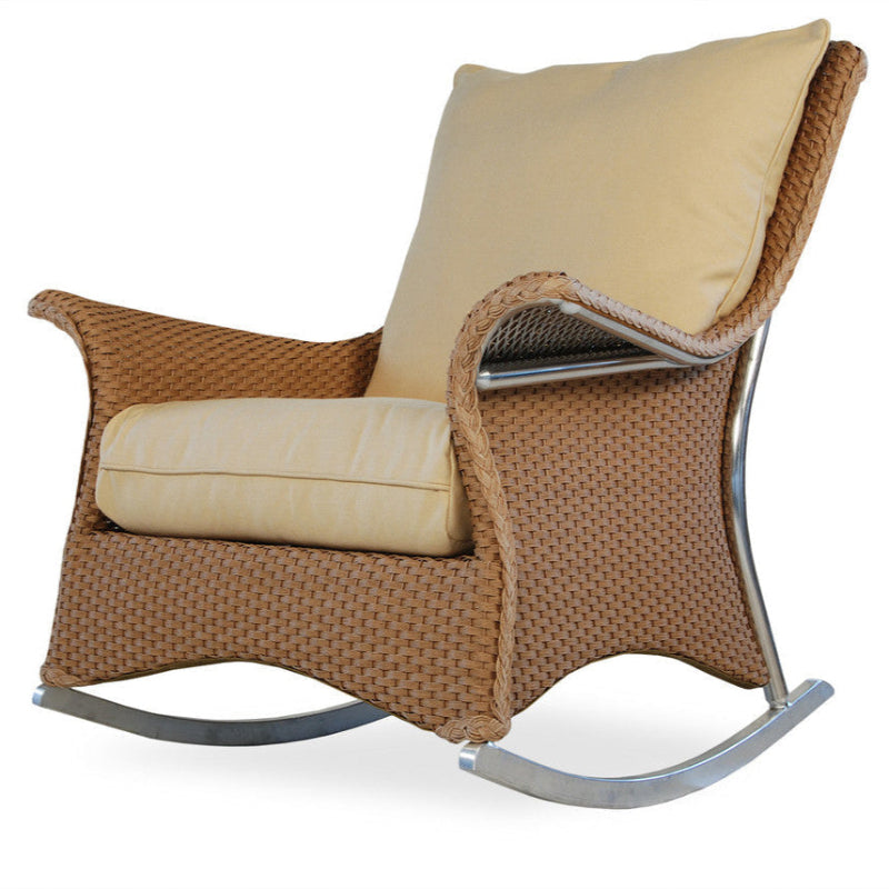 Brown wicker rocking chair with beige cushions on a white background