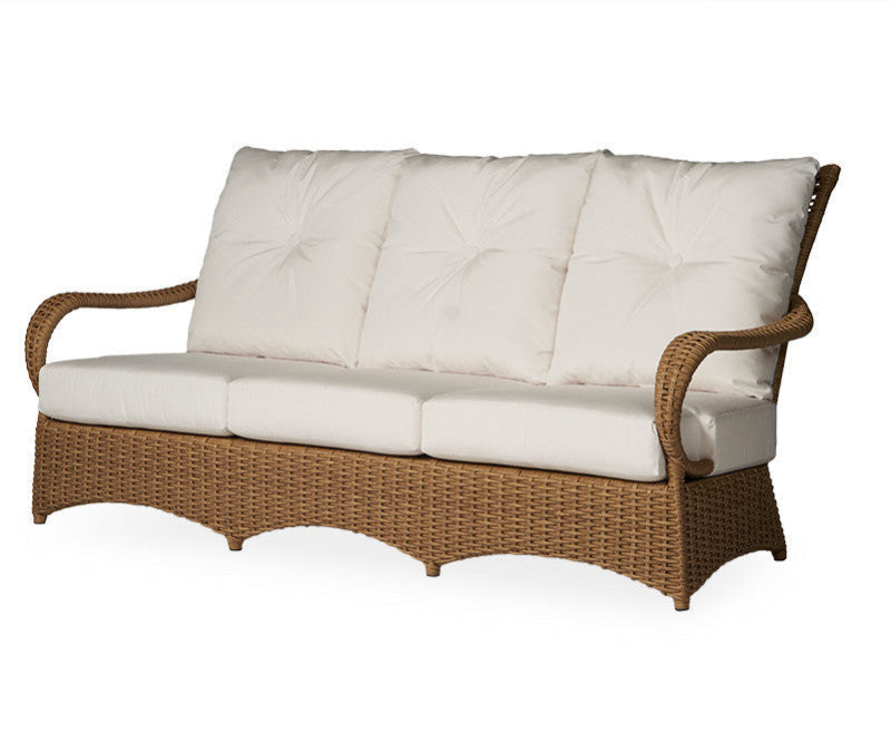 Wicker outdoor sofa with white cushions on a white background