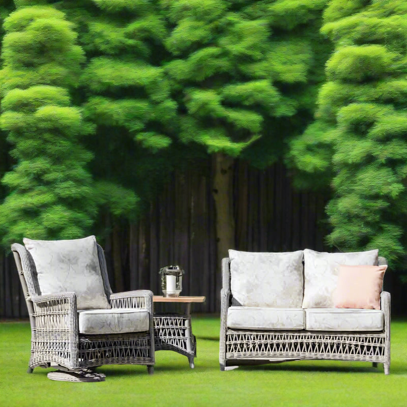 Outdoor furniture set with a chair and sofa on a wooden deck.