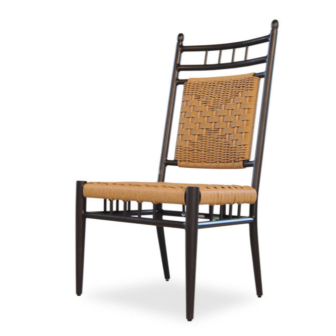 An armless dining chair with a woven vinyl seat and backrest, featuring a dark aluminum frame.