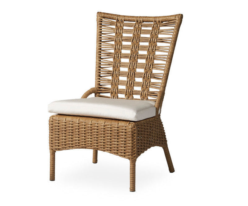 Wicker chair with a white cushion on a white background