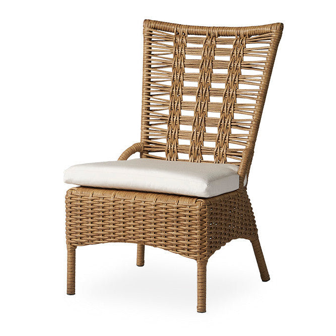 Wicker chair with a white cushion on a white background