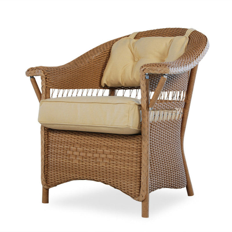Wicker chair with beige cushions on a white background