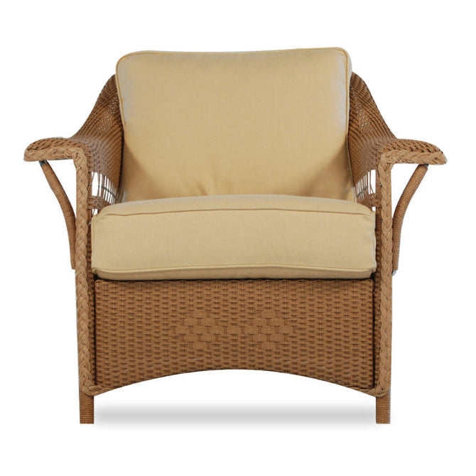 Wicker chair with beige cushions on a white background