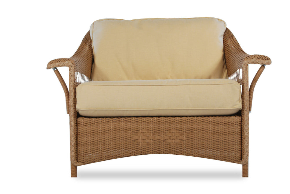 Wicker chair with beige cushions on a white background