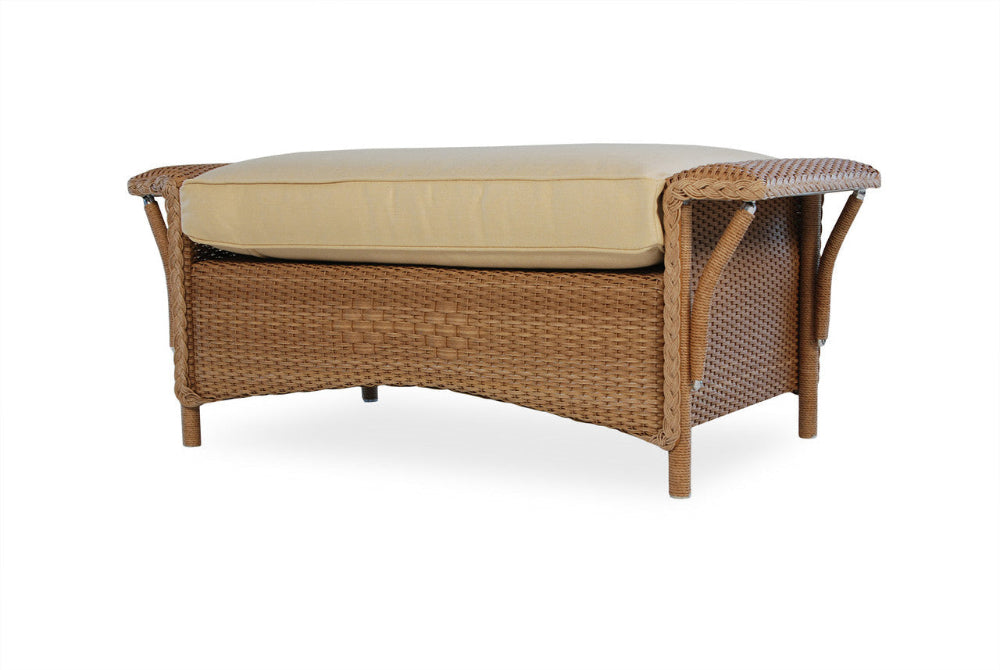 Wicker bench with beige cushion on a white background