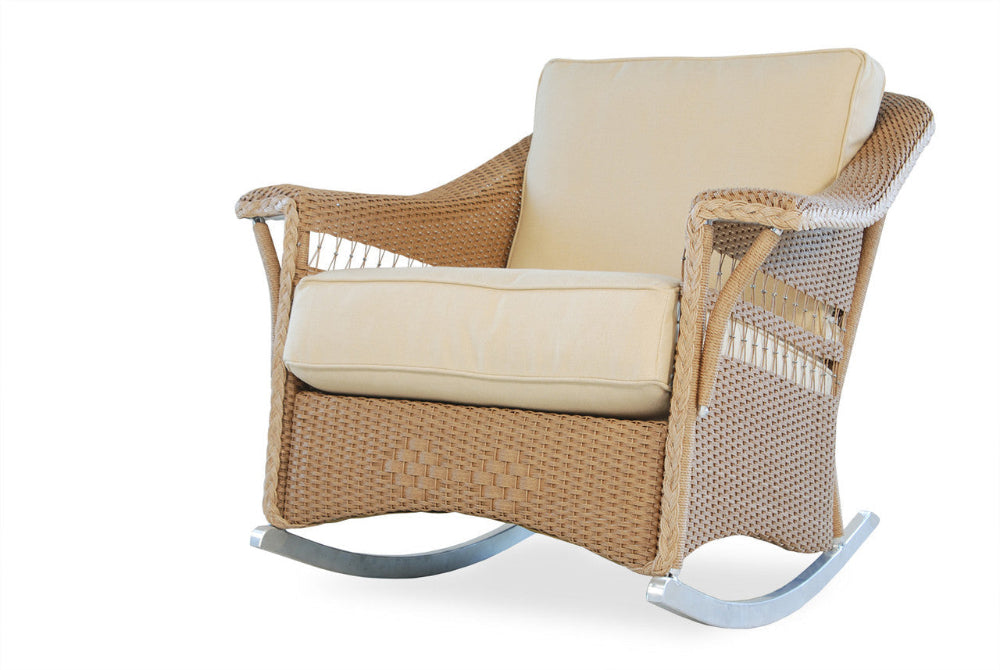 Wicker rocking chair with beige cushions on a white background