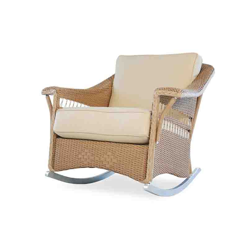 Wicker rocking chair with beige cushions on a white background