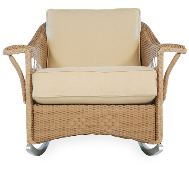 Wicker rocking chair with beige cushion on a white background