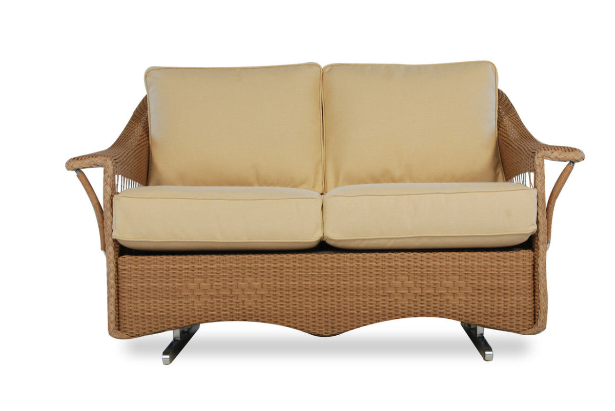 Wicker outdoor sofa with beige cushions on a white background