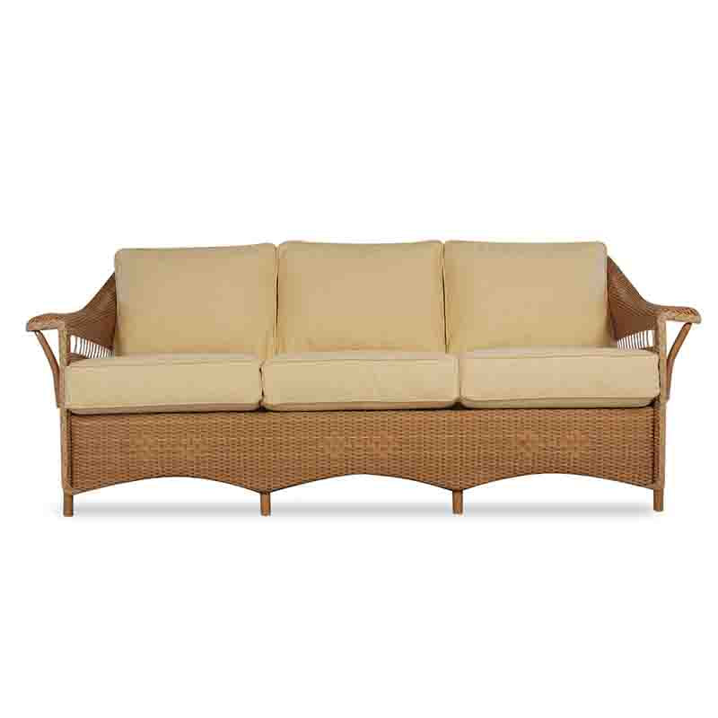 Wicker outdoor sofa with beige cushions on a white background