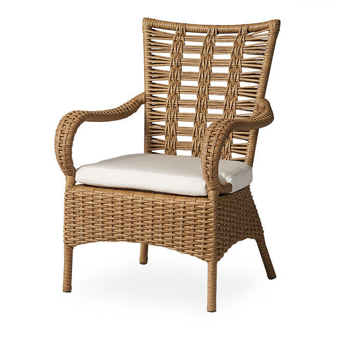 Wicker armchair with a white cushion on a white background