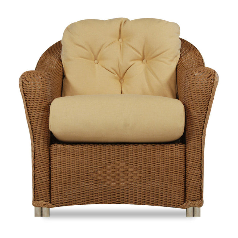 Brown wicker armchair with beige cushions on a white background
