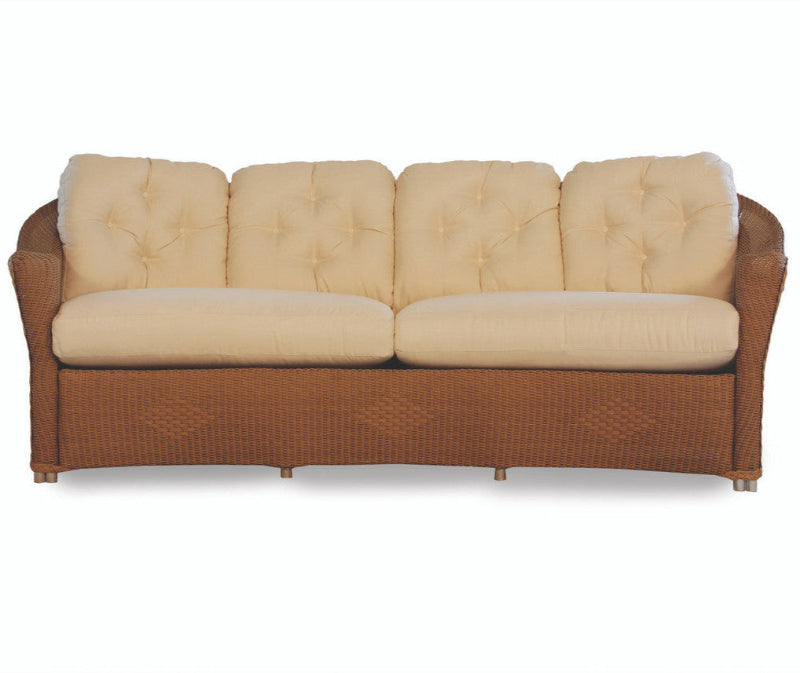 Beige cushioned sofa with brown wicker frame on a white background
