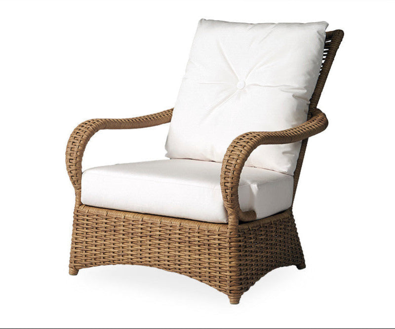 Wicker armchair with white cushion on a white background