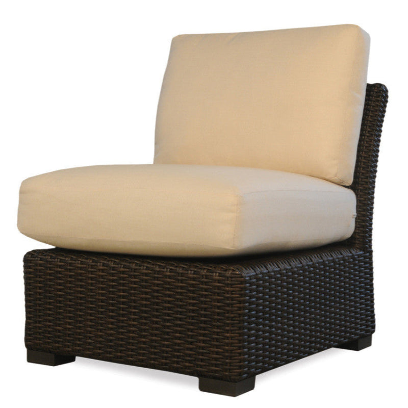 Wicker chair with beige cushion on a white background