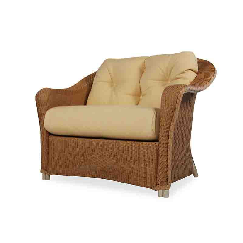 Wicker armchair with beige cushions on a white background