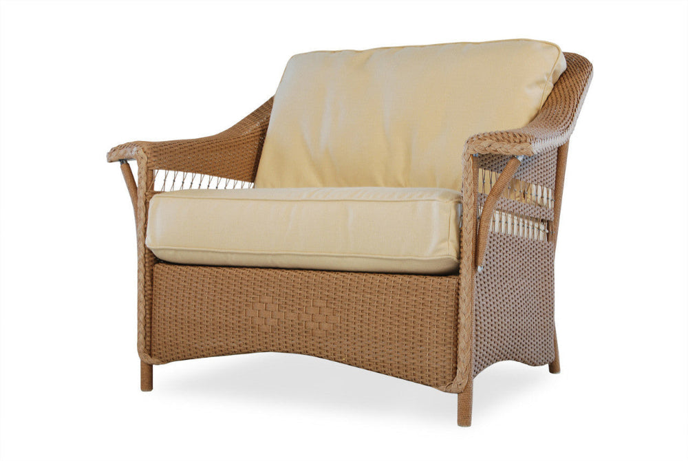 Wicker chair with beige cushions on a white background