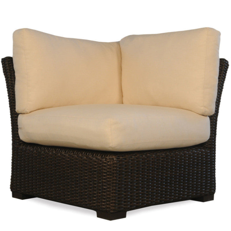 Wicker chair with beige cushions on a white background