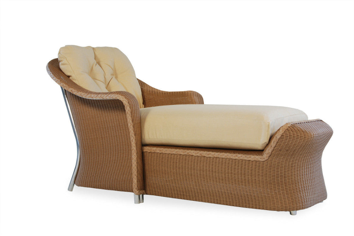 A beige wicker day chaise lounge with a built-in cushion, part of the Reflections wicker collection by Lloyd Flanders.