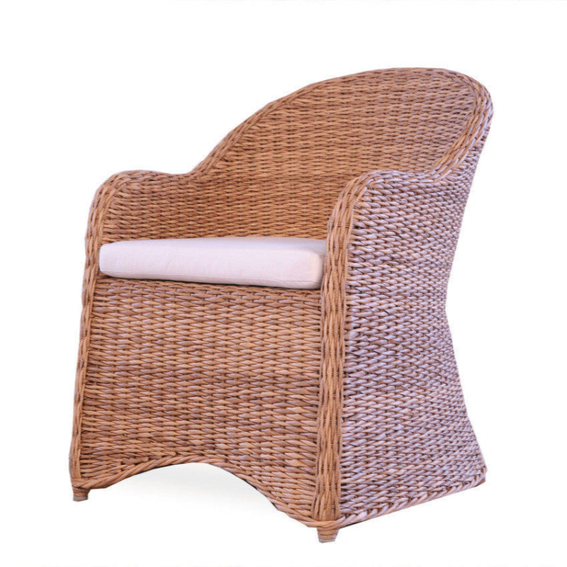 Wicker chair with a white cushion on a white background