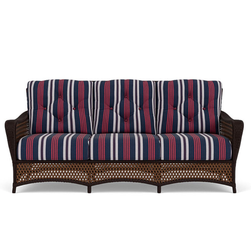 Wicker outdoor sofa with striped cushions on a white background