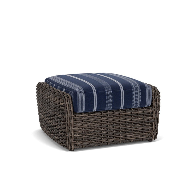 A Lloyd Flanders Largo Woven Vinyl Ottoman with a striped blue cushion on a brown woven base.