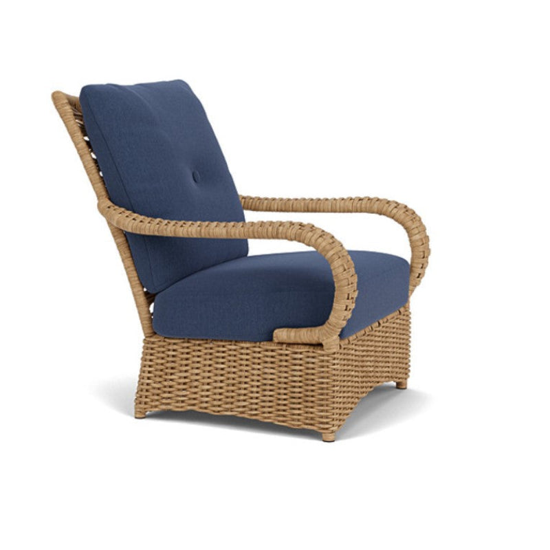 Wicker chair with navy cushions on a white background