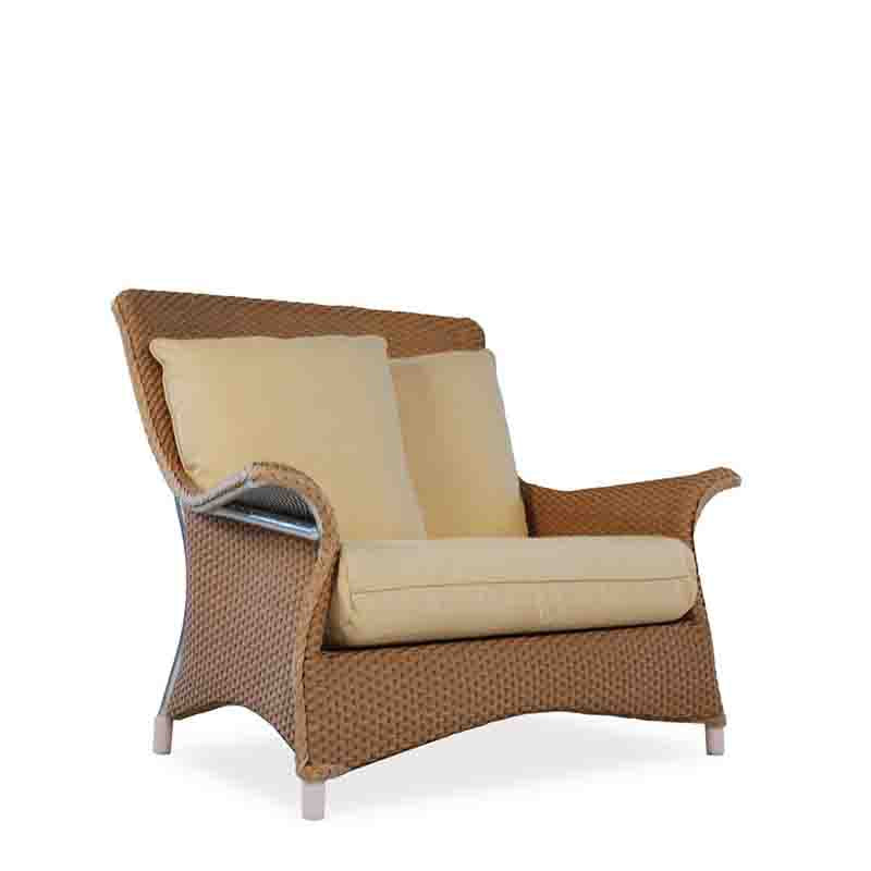 Wicker chair with beige cushions on a white background