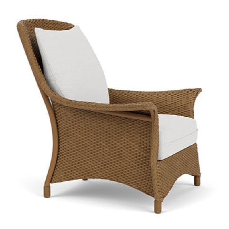 Brown wicker chair with white cushions on a white background
