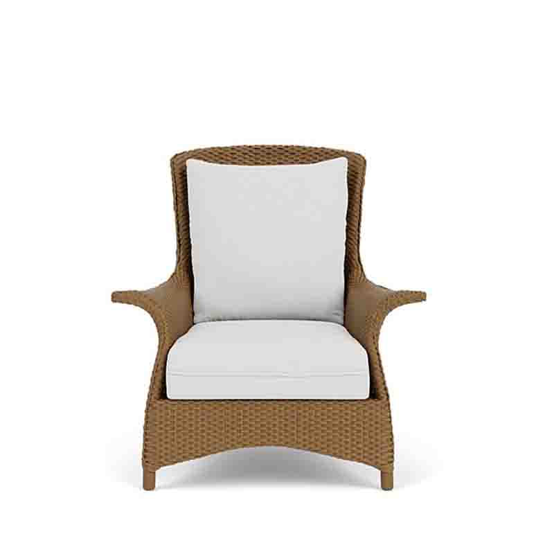 Wicker chair with white cushions on a white background