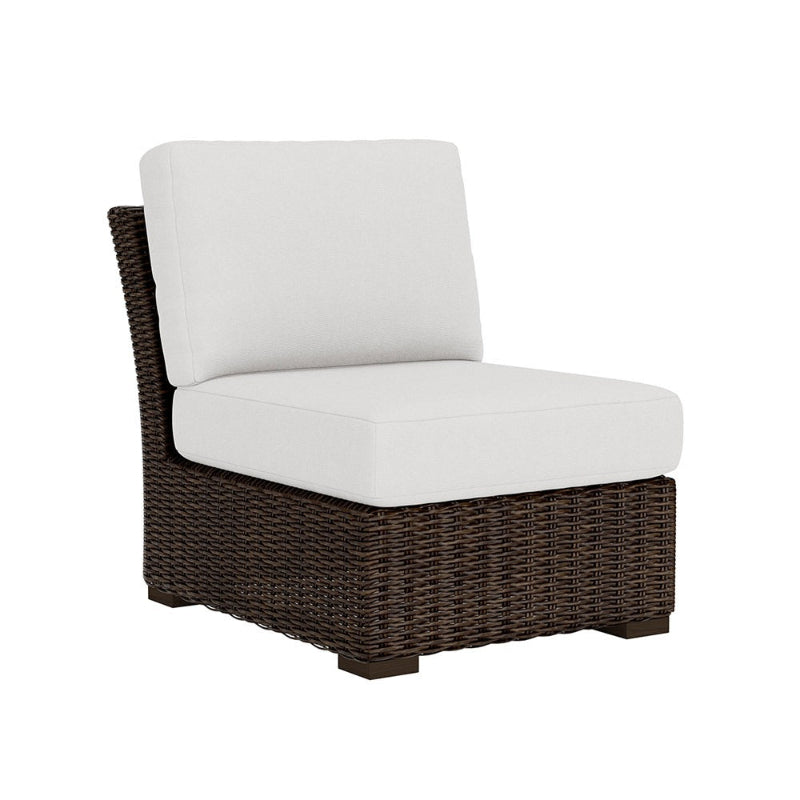 Wicker chair with white cushion on a white background
