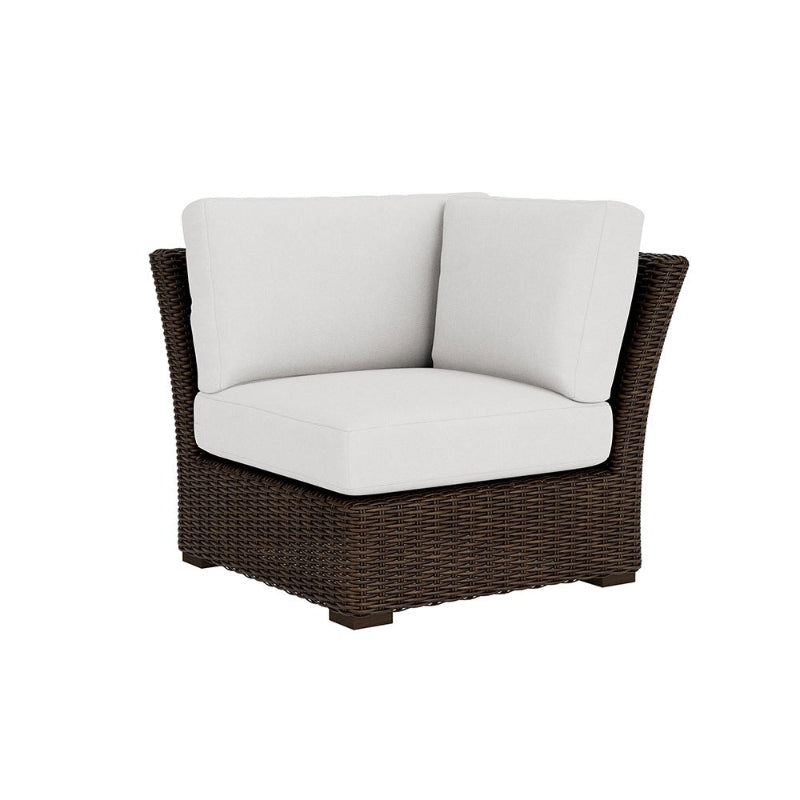 Wicker chair with white cushions on a white background