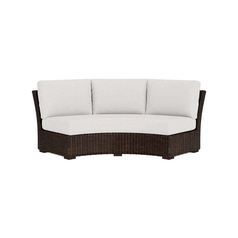 Wicker outdoor sofa with white cushions on a white background