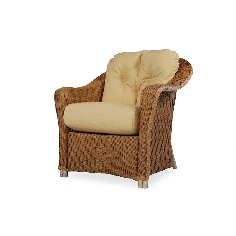 Brown wicker armchair with beige cushions on a white background