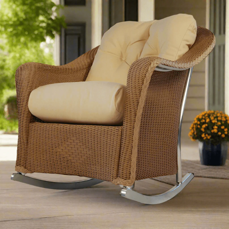 Brown wicker rocking chair with beige cushions on a patio