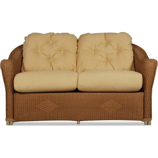 Two-seater sofa with wicker frame and beige cushions on a white background