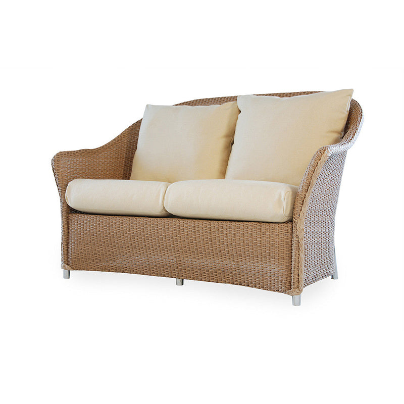 Wicker outdoor sofa with beige cushions on a white background