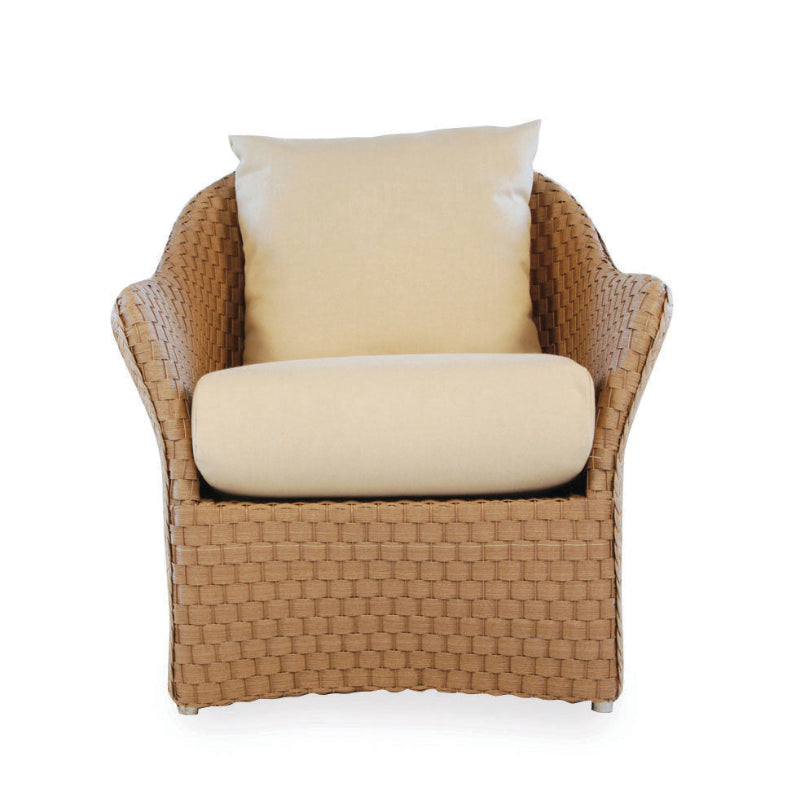 A beige wicker lounge chair with a cushioned seat and backrest, designed by Lloyd Flanders.