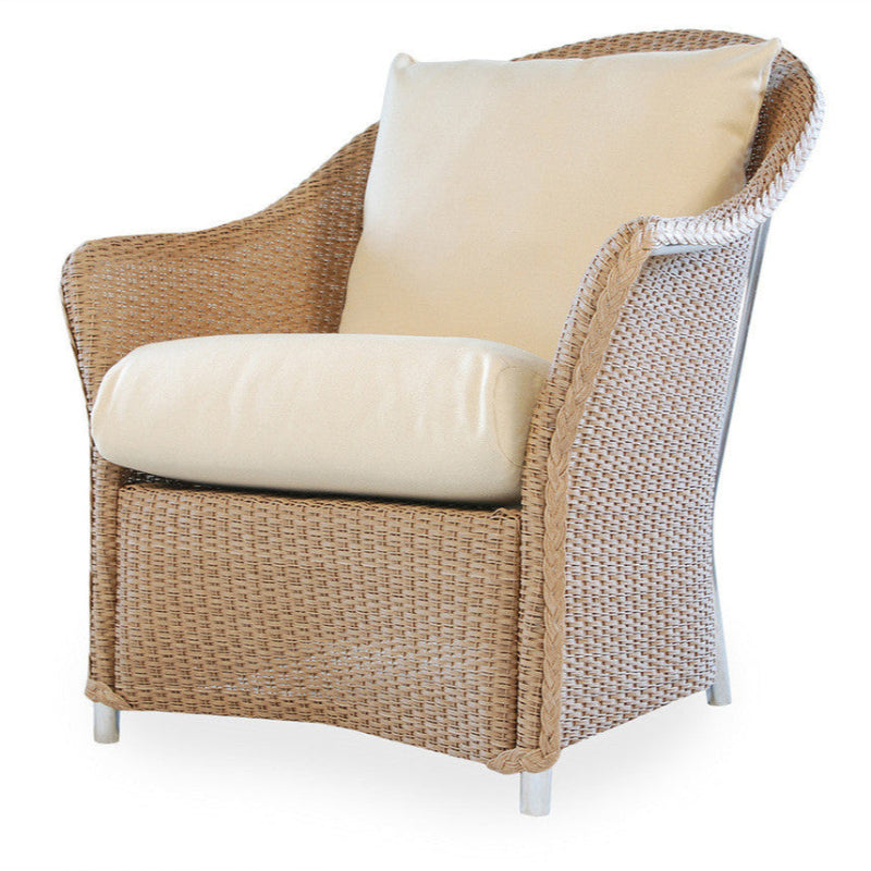 Wicker armchair with beige cushions on a white background