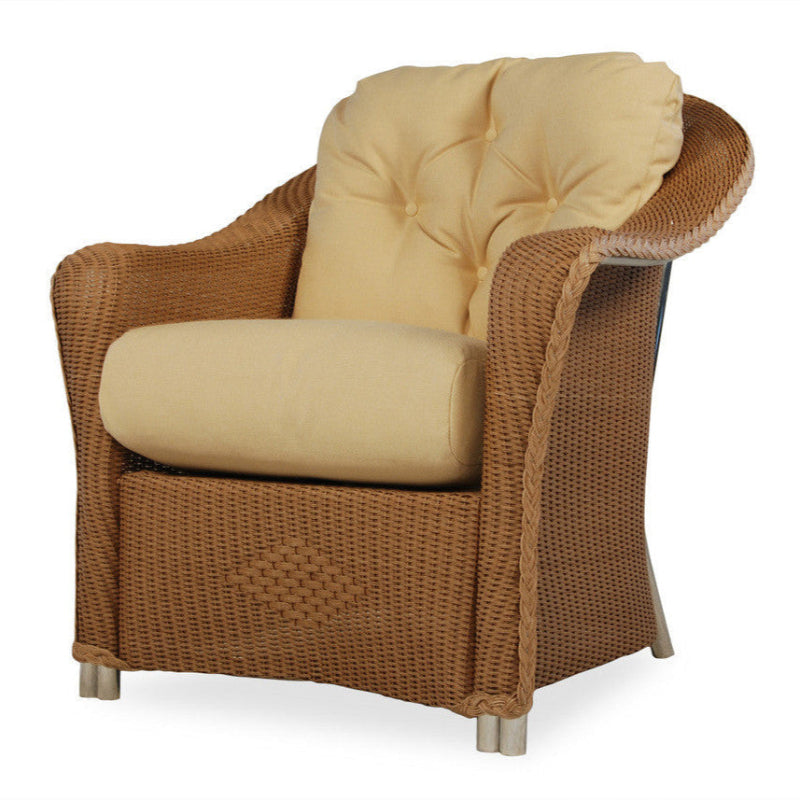 Wicker armchair with beige cushions on a white background