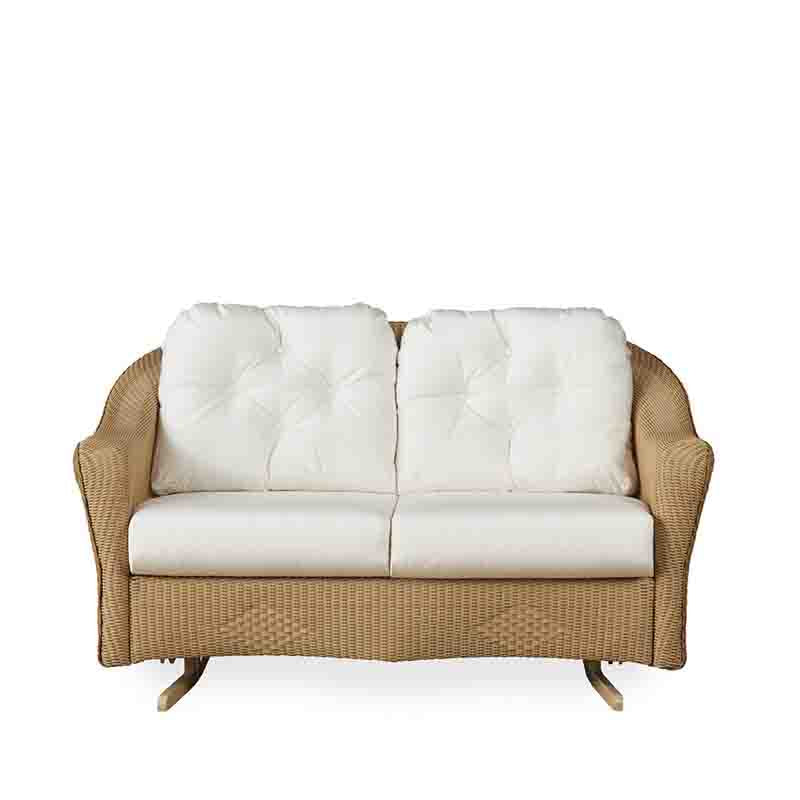 Wicker loveseat with white cushions on a white background