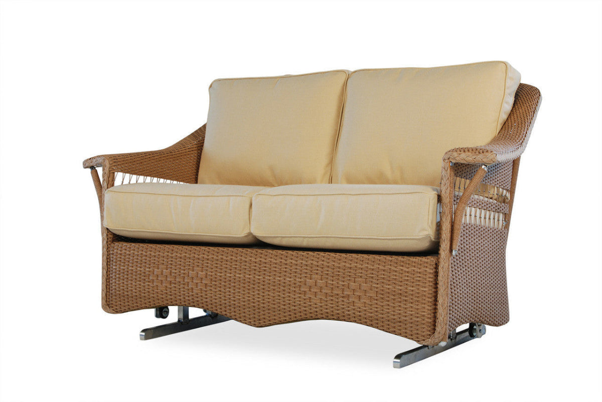 A beige wicker love seat glider with plush cushions, featuring a classic New England design with a corrosion-resistant aluminum frame.