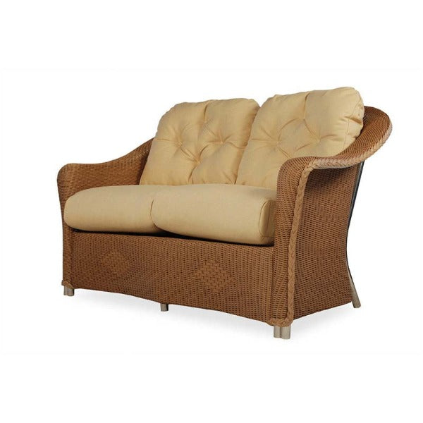 Wicker loveseat with beige cushions on a white background